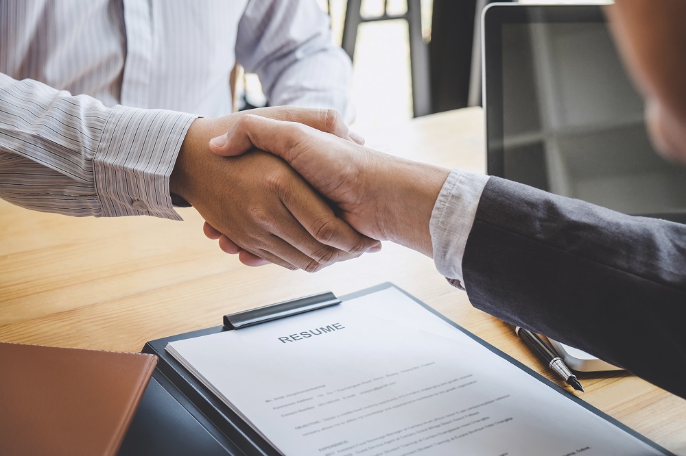 Greeting new colleagues, Handshake while job interviewing, male Greeting new colleagues, Handshake while job interviewing, male candidate shaking hands with Interviewer or employer after a job interview, employment and recruitment concept.